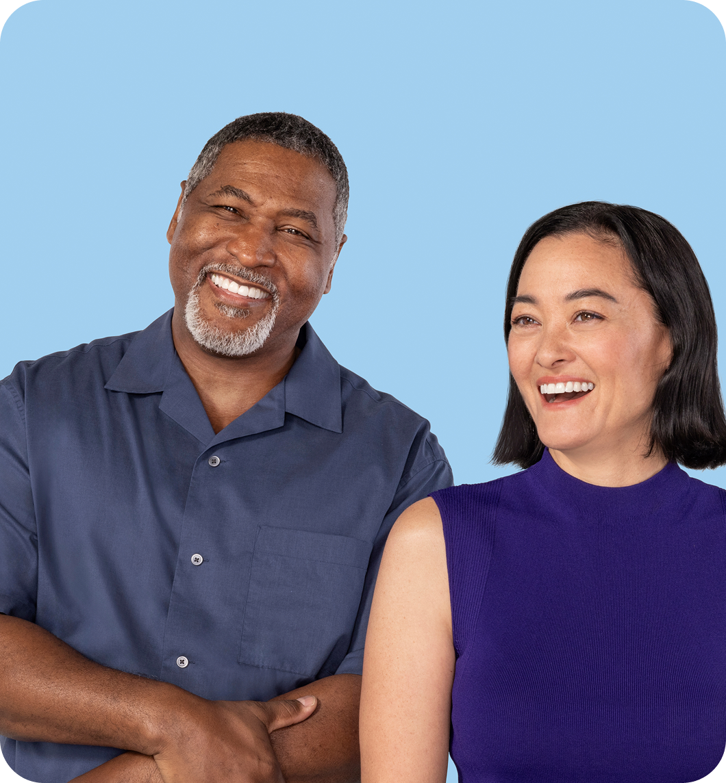Man and woman standing next to each other smiling